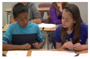 Two students are working together side by side